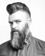Hombre con barba y peinado alto en la colección Real People de Craig Mason, fotografiado en blanco y negro con estilo editorial.