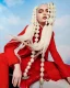 Up in the Clouds de RUSH Artistic Team con cabello rubio en burbujas largas y traje rojo editorial.